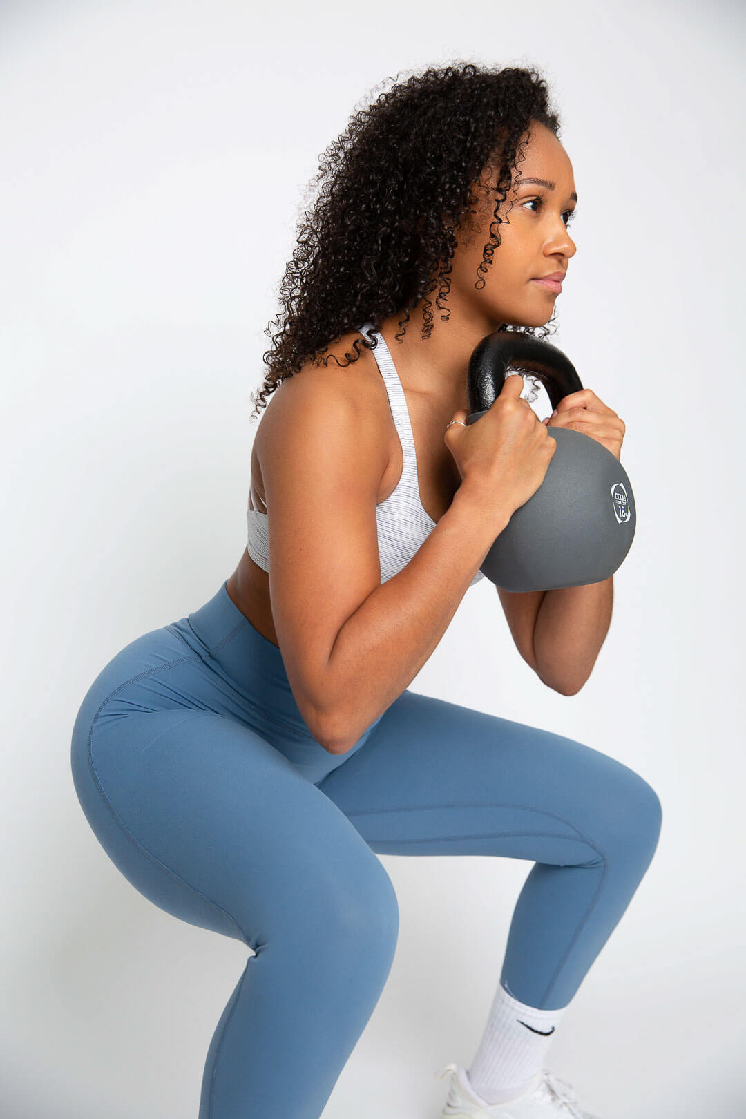 woman in fitness clothes and trainers and squat