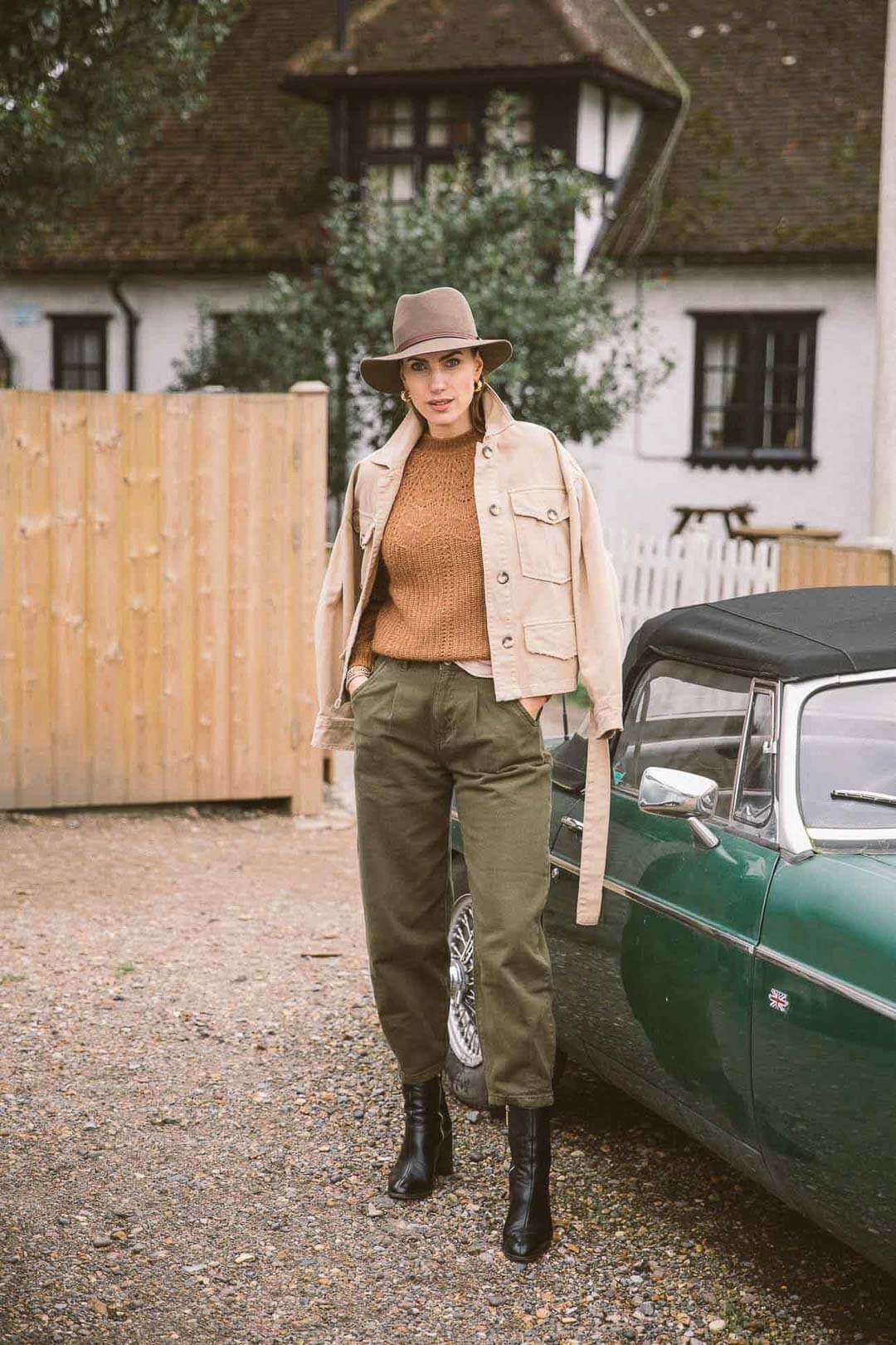 trendy women stood next to a vintage car